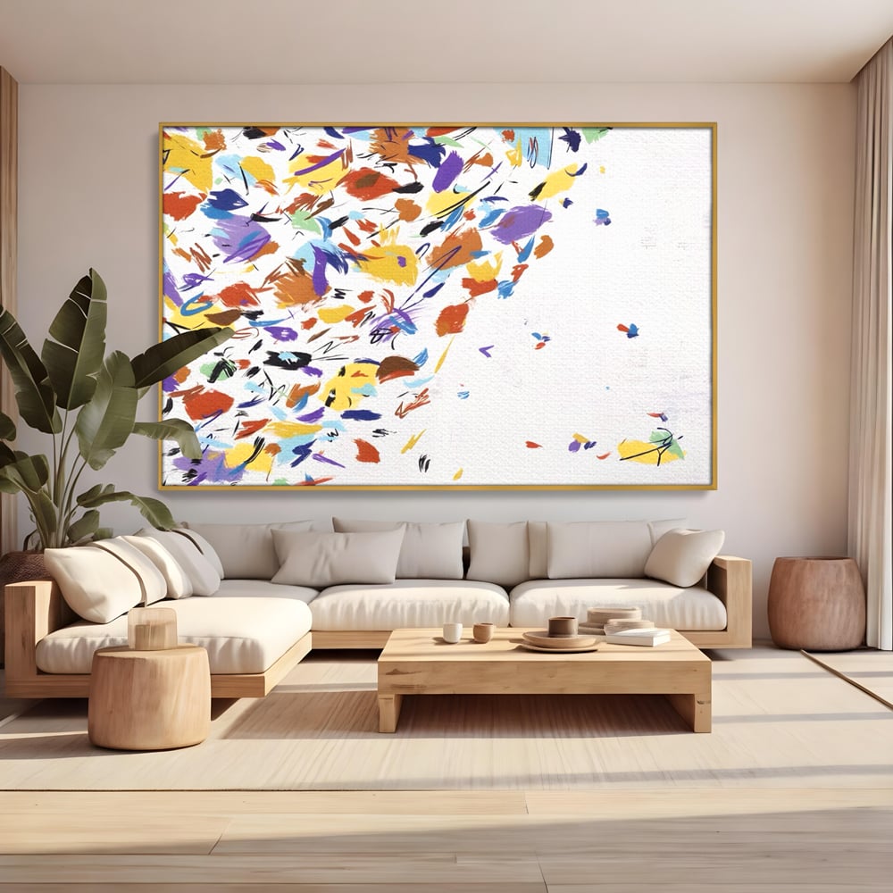 Tablou canvas cu pictura abstracta cu frunze colorate, in rama de aluminiu auriu, pe perete intr-un living